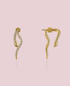 These dainty snake earrings comes with a twist, they give of the appearance that they to go through your ear, but they are made in a way where you attach the tail to the after putting them on. They are dainty and shiny and will guarantee to catch everyones attention. The Ejo earrings are part of the Dainty Collection. The Dainty Collection is renowned for its lightweight, hypoallergenic, and delicate pieces. Features: Available in 18k gold plated brass Dimensions: Head: 0.7" / Tail: 1.2" Width: Elegant Snake Shape Earrings With Ear Wire, Elegant Yellow Gold Snake Earrings, Gold Snake Shape Single Earring, Bangle Ring, Silver Jewelry Necklace, Snake Earrings, Gold Stone, Anklets, Gold Earrings