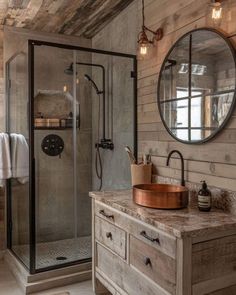 a bathroom with a sink, mirror and shower stall in it's rustic style