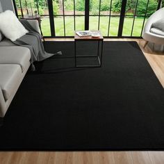 a black area rug in a living room