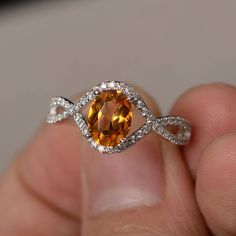 someone is holding an orange diamond ring in their hand with the words discovery diamonds on it