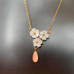 This Is A Lovely Vintage Cherry Blossom Necklace. The Flowers Are Carved Mother Of Pearl With A Coral Teardrop Dangle. Chain And Setting Are 12 Karat Gold Filled. 16” Length New Dead Stock From A Closed Jewelry Store From The 80’s. White Teardrop Necklaces For Mother's Day, White Teardrop Necklace For Mother's Day, Dainty White Flower Necklace For Anniversary, Delicate White Flower Necklace For Anniversary, White Dangle Necklaces For Mother's Day, Vintage Cherry Blossom, Cameo Choker Necklace, Cherry Blossom Necklace, Sapphire Necklace Pendants