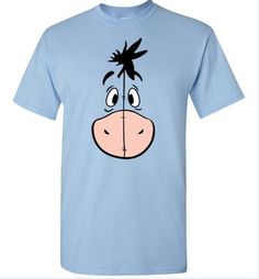 a blue t - shirt with an image of a cartoon cow's face on it