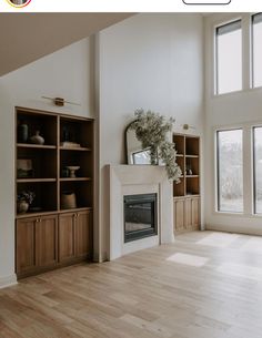 an empty living room with wood floors and white walls, has a fireplace in the center