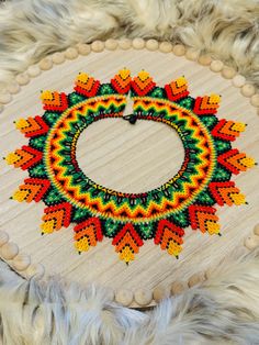 a circular beaded object on top of a fur rug with beads around the edges