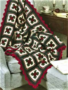 a crocheted afghan is sitting on a chair