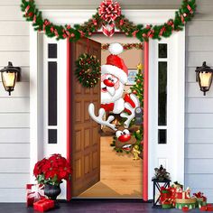 an open door decorated with christmas decorations and santa's helper on the front porch