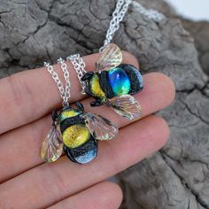 Unique dichroic glass bee necklace is a great gift for mom sister or grandma. Honey bee pendant is an absolutelly handmade jewelry made frm silver glass.  Details material: glass, dichroic glass, silver glass, metal chain width 3 cm - 1.18 inch height of the bee: 2.5 cm - 1 inch chain length: 44 cm - 17 inch (can be +-1-2 cm) Here you can find bee earrings https://www.etsy.com/listing/857932674/dangle-bee-earrings-for-women-bee?ref=shop_home_active_1 Diy Jewelry Making Tutorials, Lampwork Jewelry, Lampwork Earring, Bee Pendant, Bee Necklace, Bee Earrings, Kids Necklace, Great Gifts For Mom, Silver Glass