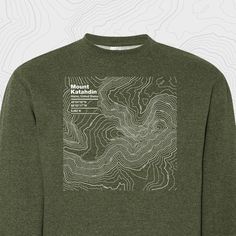 a long sleeved shirt with a map on the chest and white writing that reads mount baker