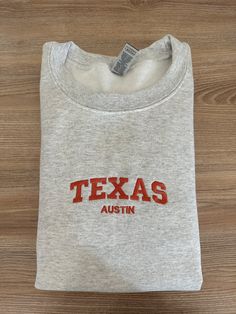 If you want a custom order or have any questions, please message me! -Austin Texas embroidered crewneck -50/50 cotton/polyester -Unisex sizing: fits true to size. Order one size up for a looser fit. Ut Austin Sweatshirt, Crew Neck T-shirt With Letter Embroidery For College, Crew Neck T-shirt With Custom Embroidery, Custom Embroidered Crew T-shirt For College, Custom Embroidery Crew T-shirt For College, Crew T-shirt With Letter Embroidery For College, College Crew T-shirt With Custom Embroidery, College Crew T-shirt With Embroidered Text, College Crew T-shirt With Letter Embroidery