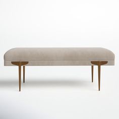 an upholstered bench with two wooden legs and a light colored fabric seat cover