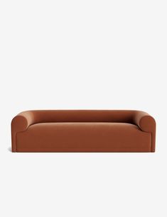 a brown couch sitting on top of a white wall