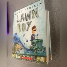 there is a children's book about lawn boy on the shelf next to it