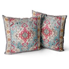 two blue and pink pillows on white background