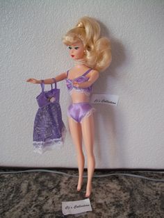 Barbie looks glamorous wearing this three piece lavender lingerie under garment set. This ensemble includes doll, bra, underwear, white shoes and slip. It is the perfect attire to wear under one of her stylish outfits.  Check out her lemon blonde ponytail just perfect for Barbie! This Barbie  is from a Mattel collection #15407 in 1995 called Enchanted Evening. This Barbie and outfit collection are new and never played.  This ensemble will make a great addition to any collection!  I am happy to combine shipping with other orders excluding the free ship items. Please message me with any questions.  Thank you for visiting my Etsy shop CjsCollection. I hope you enjoyed the selection! Have a great day. ♫ ..** ★ Ponytail Barbie, Blonde Ponytail, Enchanted Evening, Barbie Stuff, Retro Look, White Shoes, Barbie Doll, Barbie Dolls, Night Gown