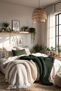 a bed with blankets and pillows on top of it in front of a large window