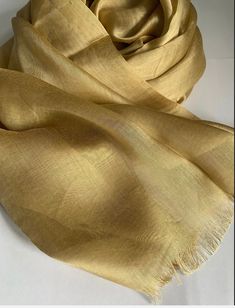 STUNNING LUXURY GOLD SCARF Beautiful delicate soft light weight fringe trim scarf  This scarf is a perfect accessory for both daytime and evening wear  Made from Rayon silk  Gold colour  180cm length x 89cm width (approx)  Note : The colour of the scarf may appear slightly different in person as screen settings and lighting can affect how it looks on the phone or computer. Elegant Beige Festive Scarves, Elegant Beige Scarves For Festive Season, Classic Gold Silk Scarf, Classic Gold Silk Scarf For Formal Occasions, Formal Gold Silk Dupatta, Elegant Yellow Silk Shawl, Formal Gold Silk Scarf, Elegant Yellow Dupatta, Elegant Gold Silk Shawl