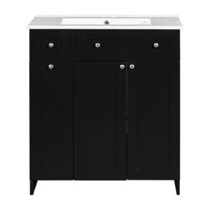 a white sink sitting under a black cabinet