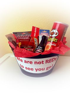 a basket filled with lots of different types of snacks and drinks sitting on top of a table