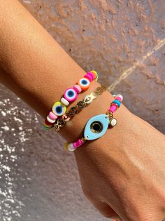 Three different summer bracelets in rainbow colors. A unique bracelet withtiny colorful evil eyes and beads, a gold bangle bracelet with tiny eyes and, and a colrful bracelet with a unique light blue evil eye at the center. You can choose and wear them all together or separetely as well. In Christina Christi Jewels store you can see more than 100 designs in Women's Bracelets. You can have them in 2-4 Days with DHL EXPRESS SHIPPING DIMENSIONS - Every bracelet, has length 16.5 cm (6,3'') - If you Coral Bracelet, Summer Bracelets, Blue Evil Eye, Beaded Anklets, Stackable Bracelets, Gold Bangle Bracelet, Unique Bracelets, Evil Eye Bracelet, Metal Charm