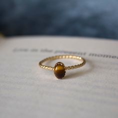 STUNNING 14k gold filled handmade tigers eye ring ✨ * Listing covers just the single tigers eye ring, other rings are sold separately. Beautiful 6x4mm tiger eye gemstone Tigers Eye is a member of the Chalcedony mineral class family. It has a silky luster and an opaque transparency. Tiger's Eye is commonly a metamorphic rock that comes in shades of reddish brown with iron stripes. The meaning of Tigers Eye is self-confidence and inner strength. Traditionally tigers eye was used to ward off curses Tiger Eye Engagement Ring, Tigers Eye Engagement Ring, Layered Rings Gold, Tiger Eye Ring For Women, Tigers Eye Jewelry, Tigers Eye Ring, Brown Ring, Class Family, Tiger Eye Ring