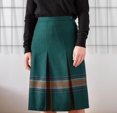 Buy 3 items and get 30% off your entire order. Limited offer. All orders are shipped via FedEx. Shipping to the US typically takes 2 to 3 business days, while within the EU, it takes 2 to 6 business days. Vintage box pleat midi skirt in a rich forest green. Crafted from pure wool, it's beautifully accented with a brown striped and plaid pattern along the pleats. Designed to hit around knee length, this skirt offers a classic yet distinctive look. Side zipper and button closure. Lined. Made in Gr Winter Skirt, Box Pleats, Wool Skirts, Pleated Midi Skirt, Kilt, White Plaid, Plaid Pattern, Forest Green, Navy And White