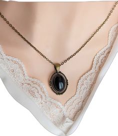 Elegant Oval Cabochon Onyx Jewelry, Elegant Cabochon Teardrop Pendant Necklace, Elegant Onyx Oval Cabochon Jewelry, Elegant Teardrop Pendant Cabochon Necklace, Vintage Gemstone Necklace With Oval Cabochon, Gothic Black Oval Jewelry, Black Oval Gothic Jewelry, Elegant Oval Bronze Necklace, Elegant Bronze Oval Necklace