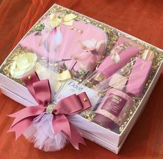 a pink gift box with flowers and personal care items