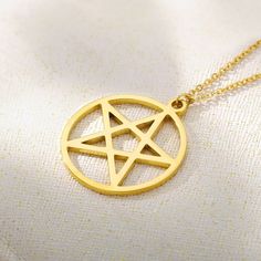 Unlock the mystical allure of our Pentagram Necklace, exquisitely forged in 14K solid gold. This captivating piece embodies strength, protection, and connection to the elements, making it more than just a piece of jewelry—it's a symbol of power. Crafted with precision, the pentagram pendant hangs gracefully on a delicate gold chain, offering a subtle yet profound statement. PRODUCT DETAILS: Choose of Material: 14K Solid Gold or 14K Gold Plated Closure: Spring ring Chain style: Cable Adjustable L Yellow Gold Star Of David Charms Jewelry, Mystical 14k Gold Jewelry Gift, Mystical 14k Yellow Gold Jewelry, Mystical 14k Gold Jewelry, Symbolic 14k Gold Jewelry With Adjustable Chain, Symbolic Yellow Gold Metal Jewelry, Mystical Yellow Gold Jewelry For Gift, Symbolic Rose Gold Brass Jewelry, 14k Gold Symbolic Jewelry With Adjustable Chain