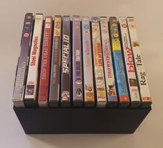 a bunch of dvd's are stacked on top of each other in a black holder