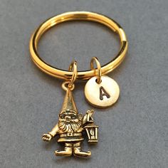 a gold keychain with a gnome charm