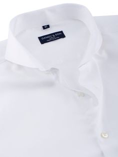 Crafted from a high-quality, 100% cotton crisp white fabric that's both delicate and soft to the touch. A non-iron, wrinkle-free finish ensures that you always look sharp and professional, no matter what your day throws at you. Our Dandyfit™ range ensures a sleek and modern silhouette, with angled barrel cuff for a touch of sophistication. Featuring our signature Extreme Cutaway Collar, complemented with mother of pearl buttons, this shirt makes a bold statement that sets you apart from the crow Classic Wrinkle-resistant Business Casual Tops, Classic Wrinkle-resistant Tops For Business Casual, Elegant Business Tops Wrinkle-resistant, Elegant Wrinkle-resistant Business Top, Elegant Business Top With Wrinkle-resistant Fabric, Classic Slim Fit Wrinkle-resistant Tops, Classic Wrinkle-resistant Business Tops, Elegant Wrinkle-resistant Work Tops, Elegant Wrinkle-resistant Tops For Work