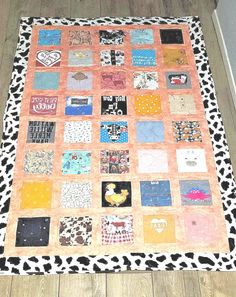 a cow print rug on the floor in front of a wall with a black and white border