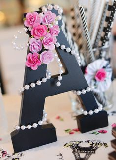 the letters are decorated with flowers and pearls