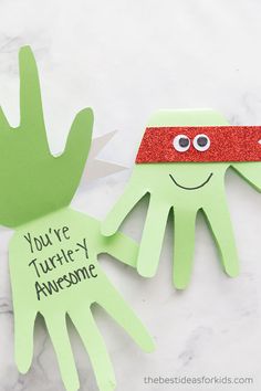 two paper hand puppets with the words you're turtley awesome and an image of a green hand