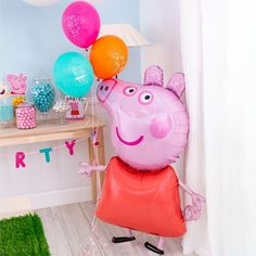 a peppa pig balloon is holding some balloons