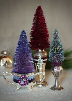 three small christmas trees sitting next to each other