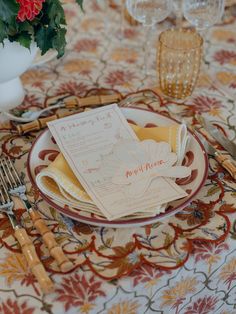 the table is set with flowers and place settings