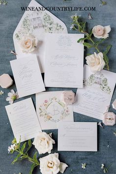 the wedding stationery is laid out with flowers