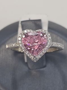 a pink heart shaped diamond ring on display