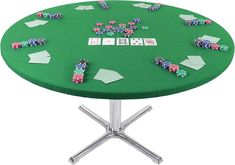 a green table topped with lots of cards and dice on top of metal pedestals