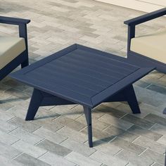 two chairs and a table on a brick floor