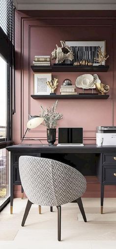 a home office with pink walls, black desk and white chair in front of the window