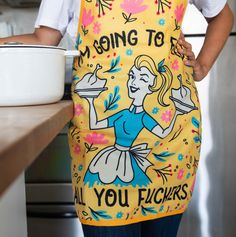 a woman wearing an apron holding a bowl