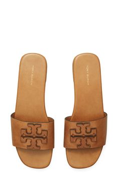 Dimensional logo detailing stands out atop the vamp of this laid-back leather slide sandal. Flat sole Leather upper, lining and sole Imported Classic Tan Sandals With Leather Lining, Tan Leather Footbed Slip-on Sandals, Classic Tan Sandals With Leather Sole, Classic Flat Slides With Removable Insole, Classic Tan Slip-on Sandals, Calf Leather Slip-on Sandals With Cushioned Footbed, Classic Tan Leather Sandals, Classic Slides With Removable Insole, Tan Flat Sandals With Leather Footbed