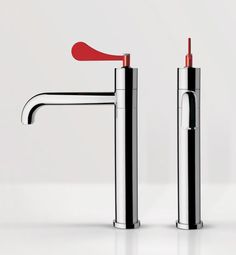 two chrome faucets with red handles on white background