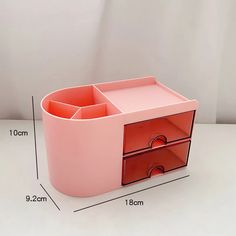 a pink desk with two drawers and measurements for each drawer on the bottom half of it