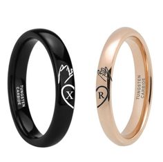 two wedding rings, one black and one rose gold