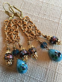 Vintage Blue Millefiori with Flowers Pendants. Vintage Blue Wedding Cake Beads Vintage Blue Cathedral Beads. Vintage Brass Leverback Closure Size  :     2 3/4  inches     ( 7 cm) Nickel Free Czech Glass Wedding Jewelry, Nickel-free Czech Glass Earrings For Wedding, Nickel-free Czech Glass Wedding Earrings, Elegant Turquoise Chandelier Earrings With Round Beads, Elegant Turquoise Chandelier Earrings, Czech Glass Dangle Earrings For Wedding, Blue Dangle Chandelier Earrings For Celebration, Wedding Czech Glass Dangle Earrings, Blue Dangle Jewelry With Bead Caps