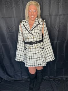 She's truly one of a kind--timeless, classy, and stunning. This is a fabulous quality style to last a lifetime. Super high quality, black, white, and gold plaid, tweed material. Fully lined. Stunning cape style long sleeves take this dress to another level. Shoulder pads, ornate shoulder detail, and edgy collar give this dress a timeless cape silhoette, making her a real standout. Double breasted front closure with statement gold buttons. Black belt included. True to size with no stretch in the Long Sleeve Tweed Dress For Fall Evenings, White Long Sleeve Tweed Dress For Party, Plaid Dresses For Fall Party, Long Sleeve Tweed Dress For Evening In Fall, White Tweed Dress For Fall Parties, White Tweed Dress For Formal Fall Occasions, Evening Long Sleeve Tweed Dress For Fall, Elegant Black Plaid Dress For Fall, Elegant Plaid Dress For Party