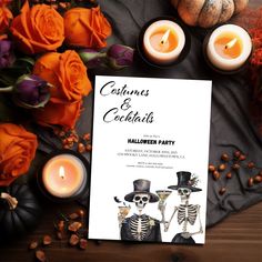 a halloween party with candles, flowers and skulls on the table in front of it